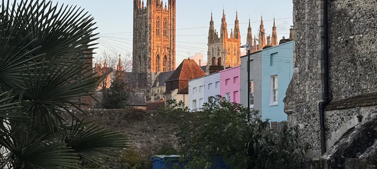 Canterbury cathedral and colourful houses in winter light