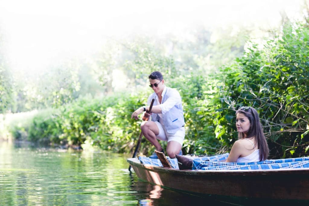 Couple enjoying a nature punting tour surrounded by greenery